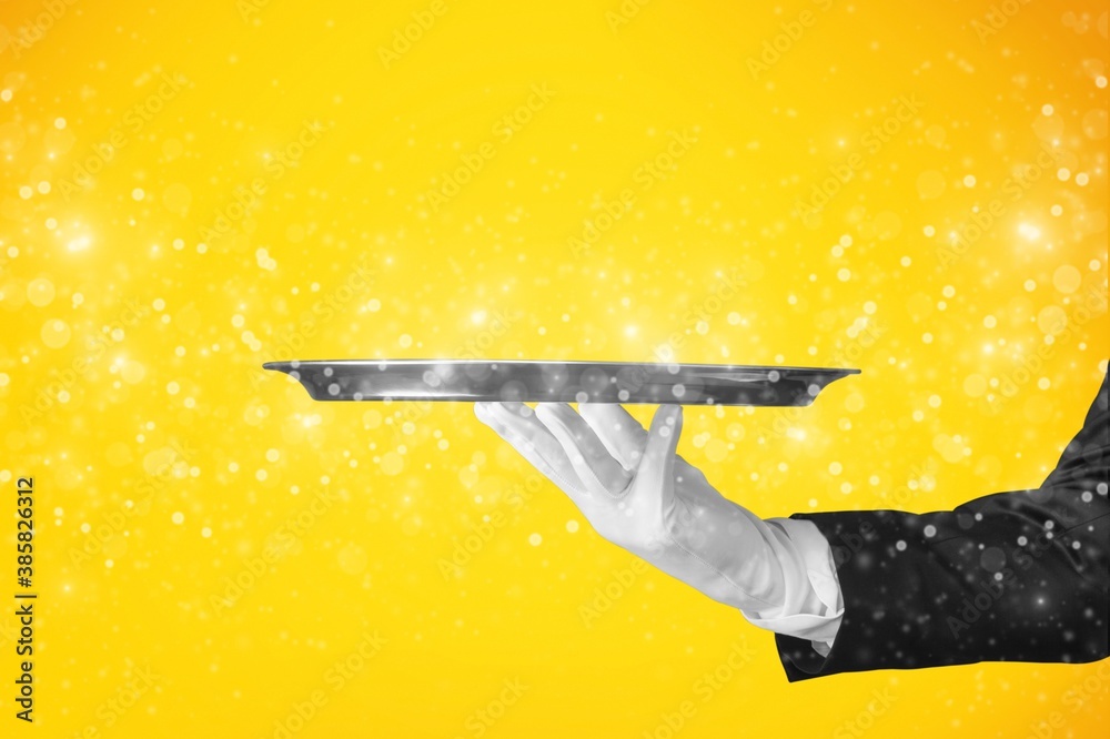 Elegant waiter hand in white glove holding an empty plate