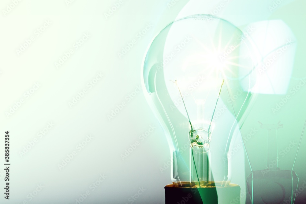 Glowing glass light bulb on background