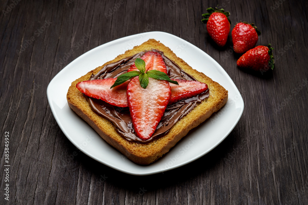 Pan tostado con fresas y crema de avellana.