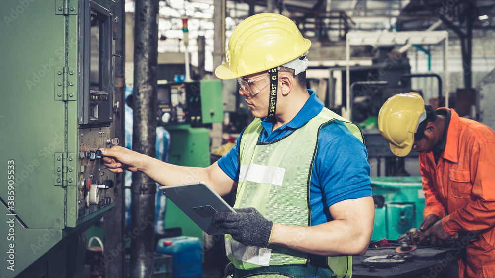 Smart factory worker using machine in factory workshop . Industry and engineering concept.