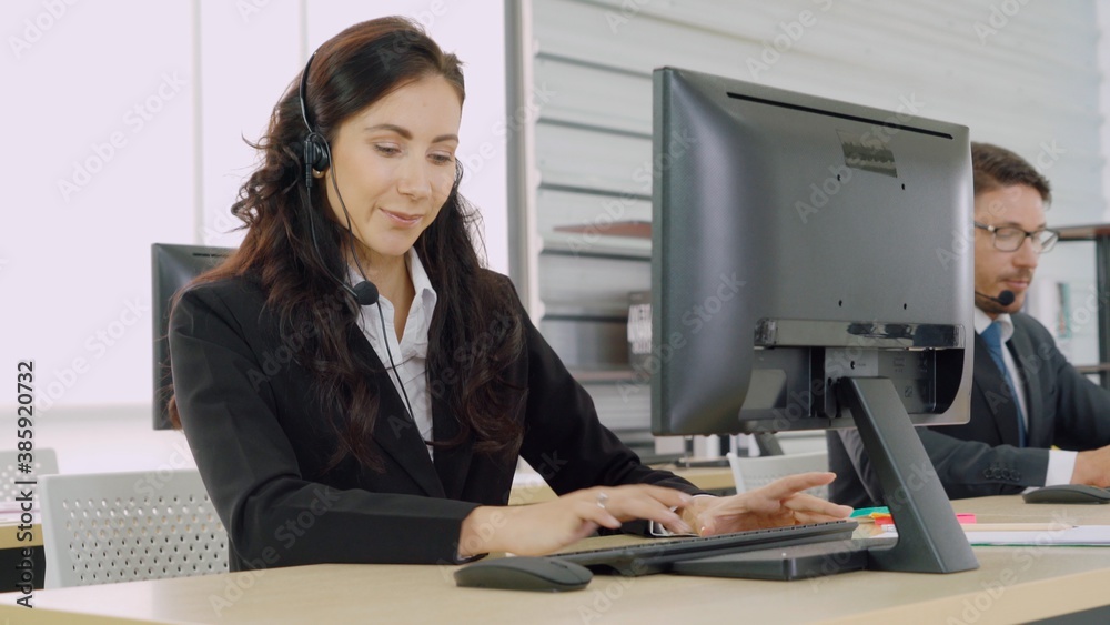 Business people wearing headset working in office to support remote customer or colleague. Call cent