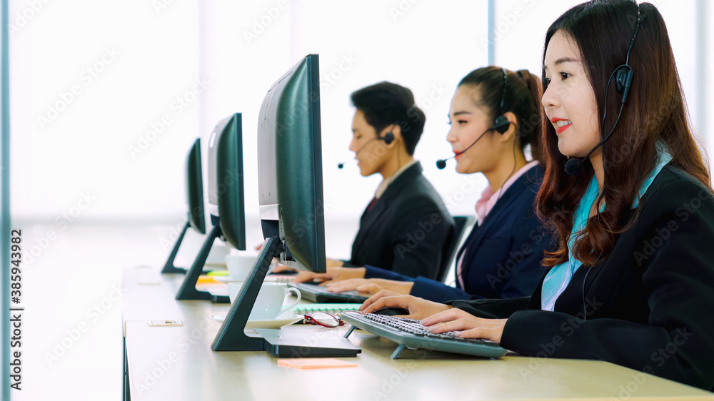 Business people wearing headset working in office to support remote customer or colleague. Call cent