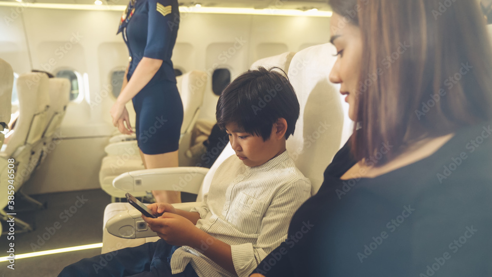 Cabin crew provide service to family in airplane . Airline transportation and tourism concept.