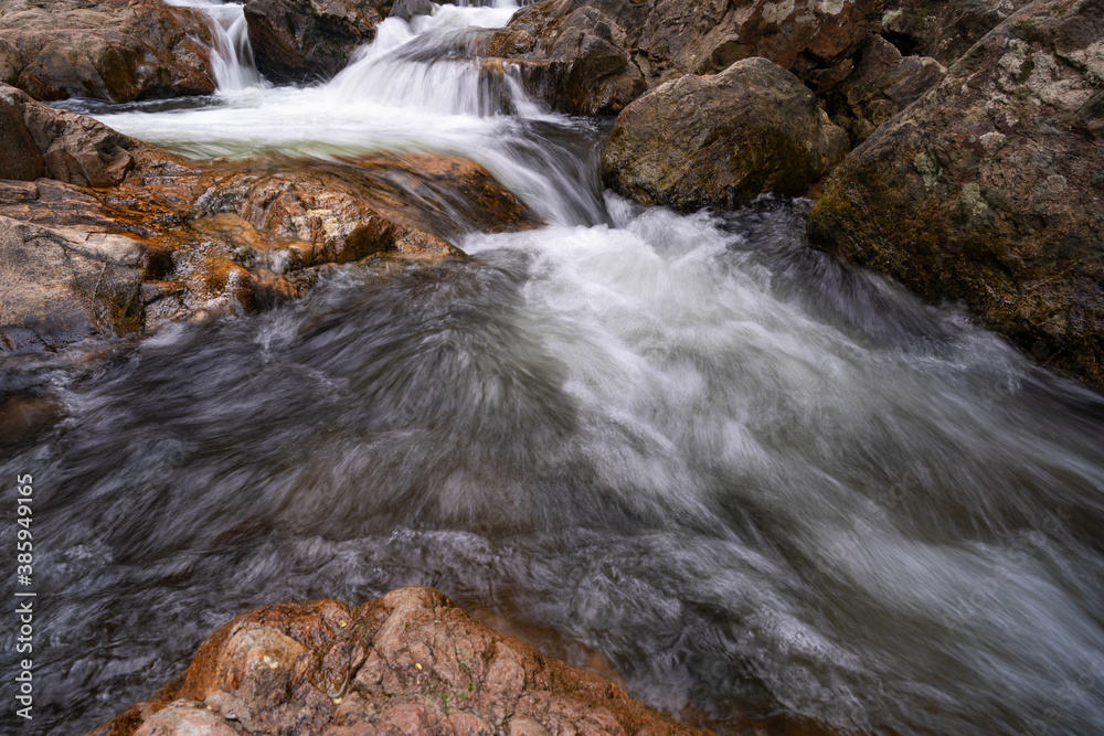 Flowing water in waterfall stream rocks flow.