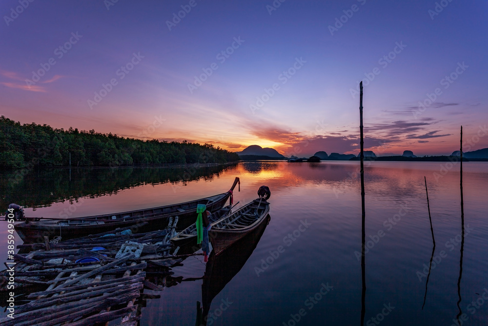 Longtail boats with coastal fishing village ,Beautiful scenery morning sunrise over sea and mountain