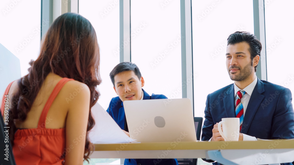 Job seeker in job interview meeting with manager and interviewer at corporate office. The young inte