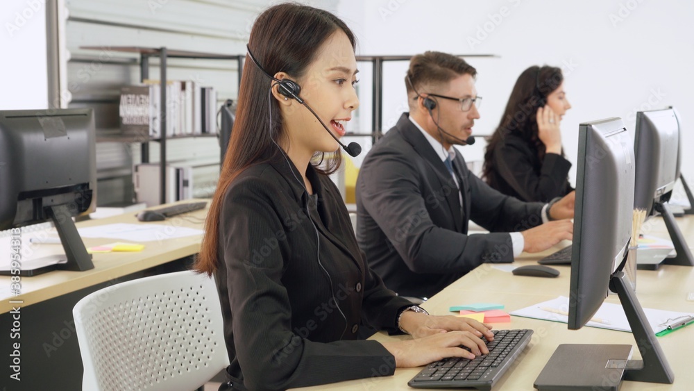 Business people wearing headset working in office to support remote customer or colleague. Call cent