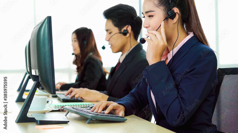 Business people wearing headset working in office to support remote customer or colleague. Call cent