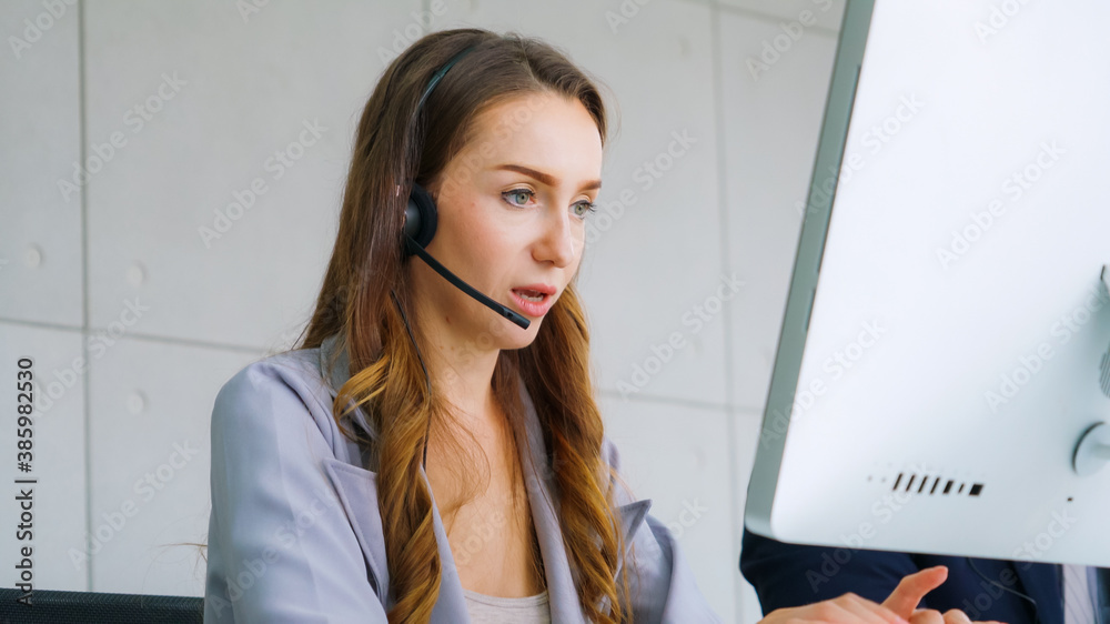 Business people wearing headset working in office to support remote customer or colleague. Call cent