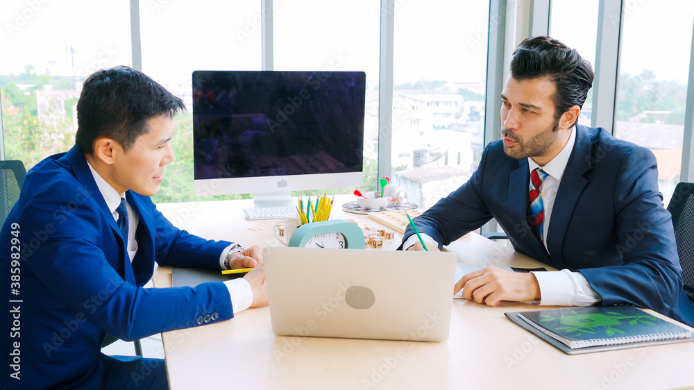 Two business people talk project strategy at office meeting room. Businessman discuss project planni