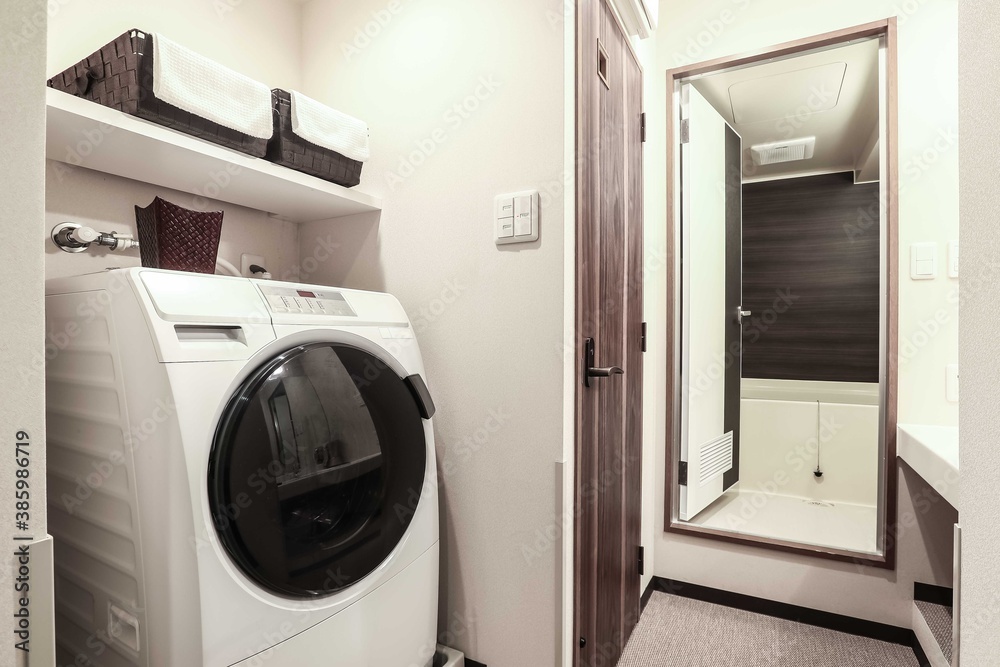 Large washing machine in the laundry room connected to the bathroom in a modern apartment