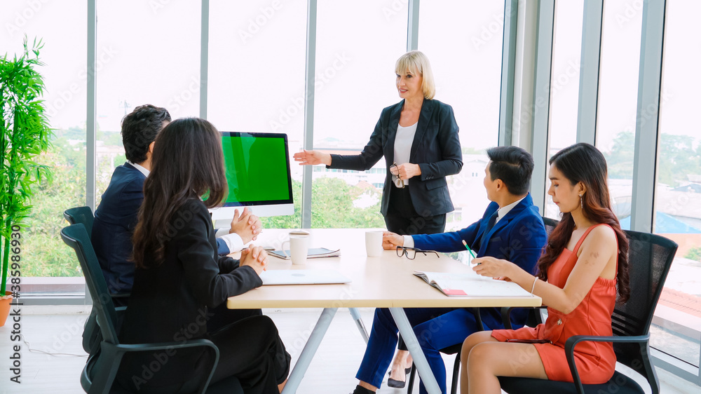 Business people in the conference room with green screen chroma key TV or computer on the office tab