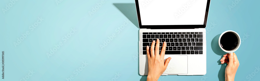 Person using a laptop computer from above