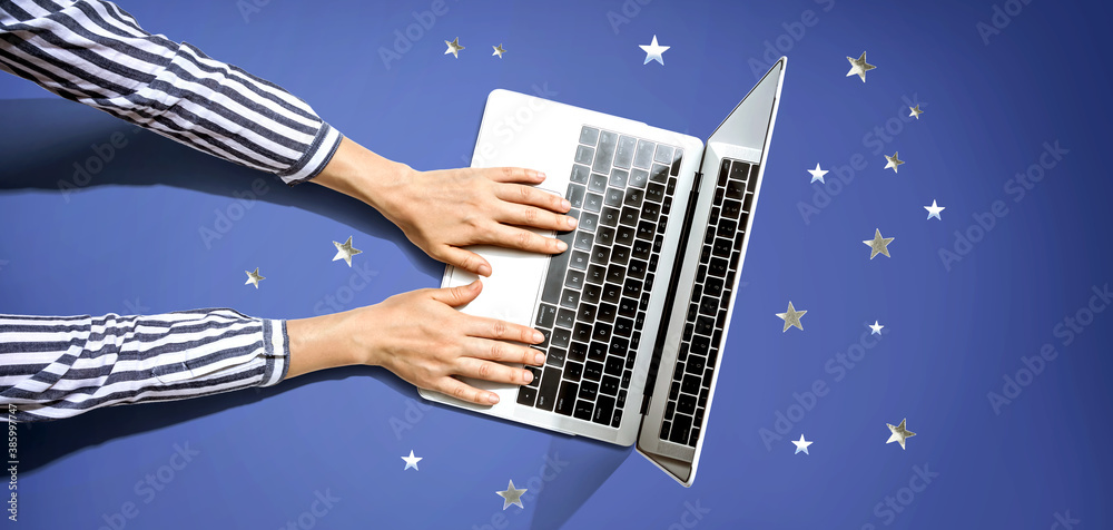 Person using a laptop computer with small stars from above