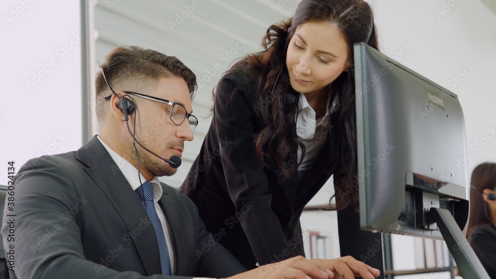 Business people wearing headset working in office to support remote customer or colleague. Call cent