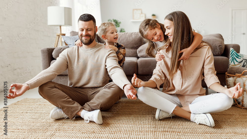 Happy parents  meditating in room with playful kids.