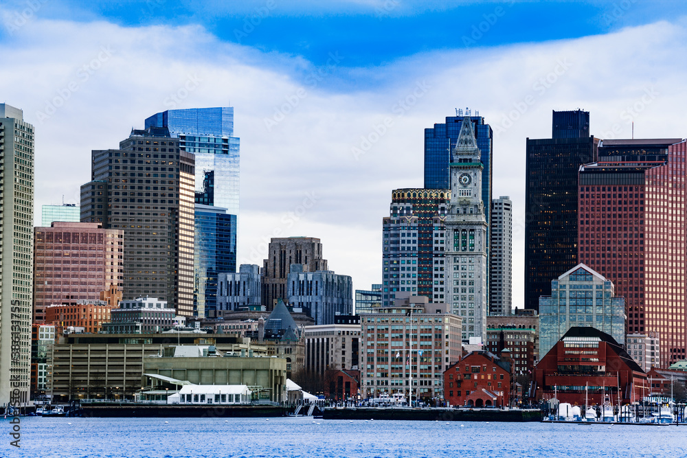 Boston city downtown view with clocktower from East side of the inner harbor Massachusetts, USA