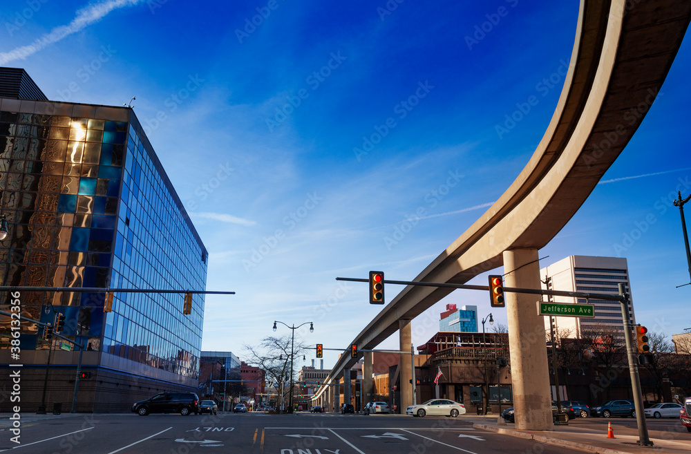 Light rail line bridge and street view of Jefferson Avenue in Detroit, Michigan, USA