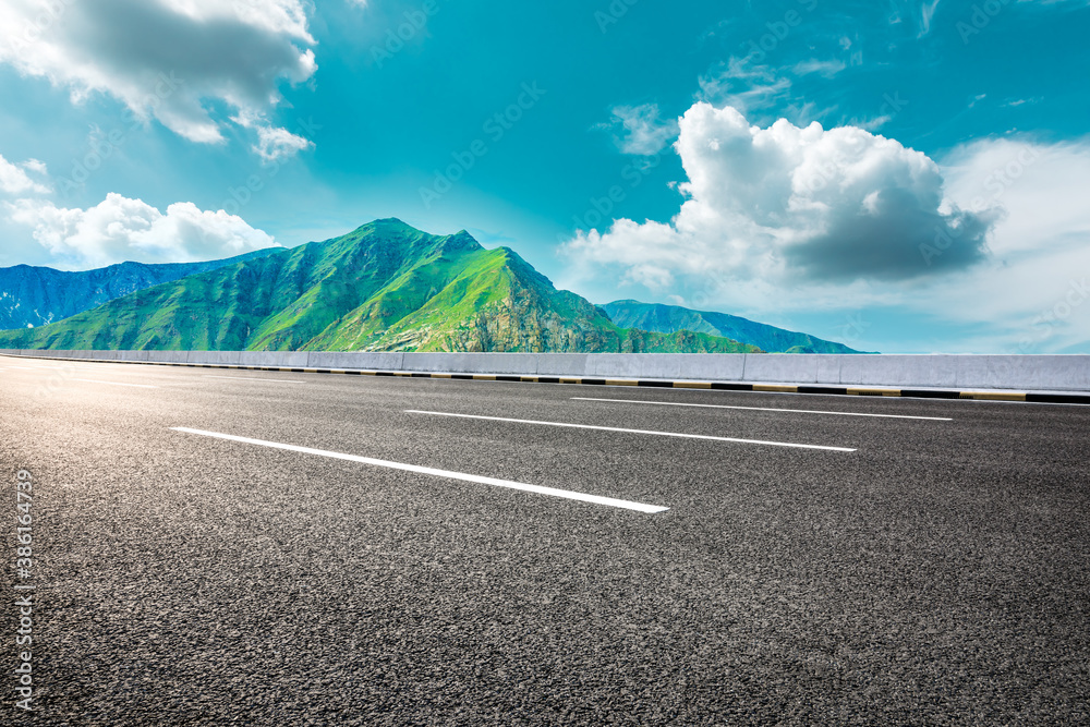 New asphalt road and green mountain with sky cloud natural scenery.