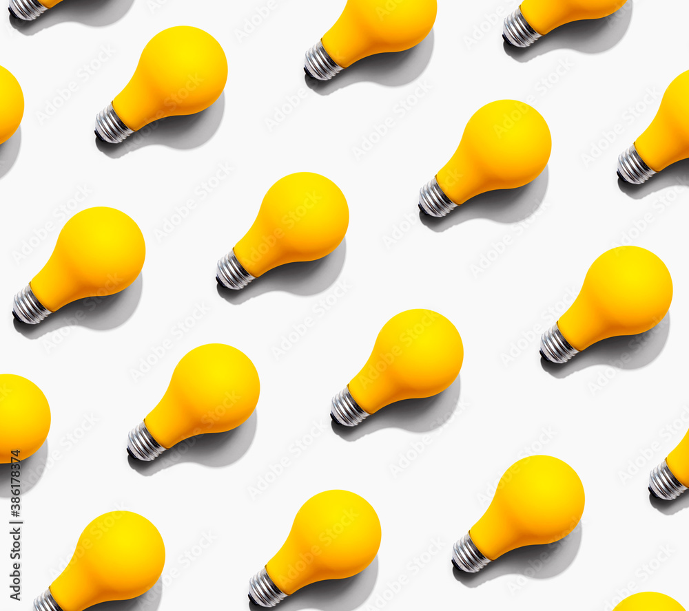 Yellow light bulb pattern with shadow - flat lay