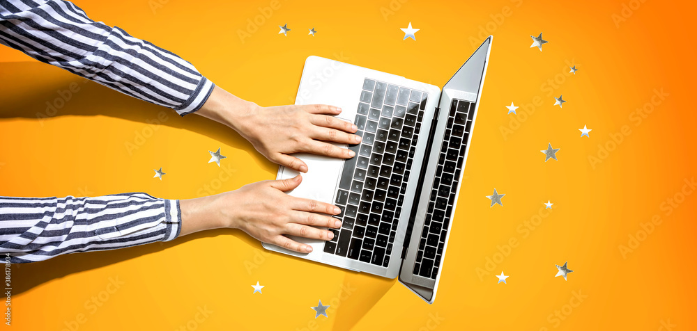 Person using a laptop computer with small stars from above