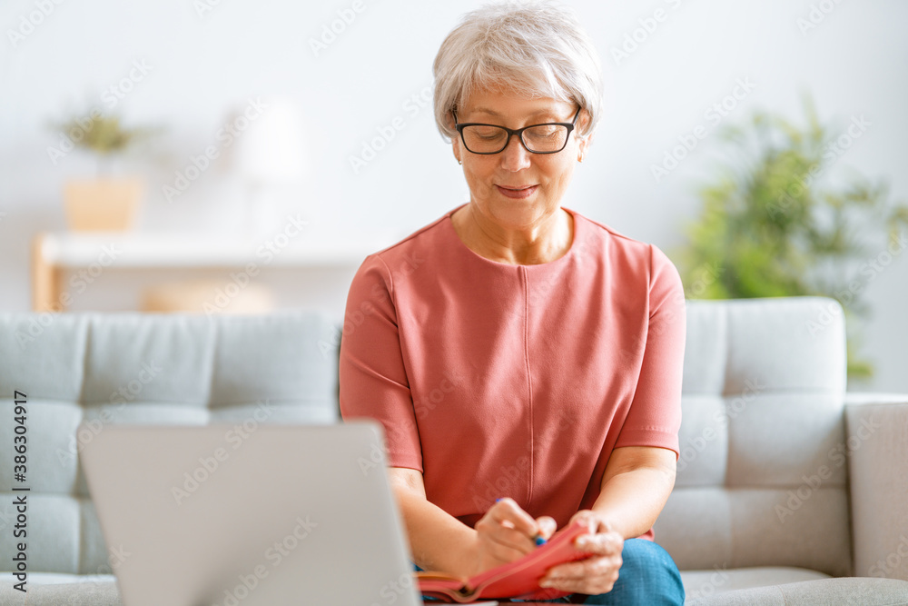 senior woman is using laptop