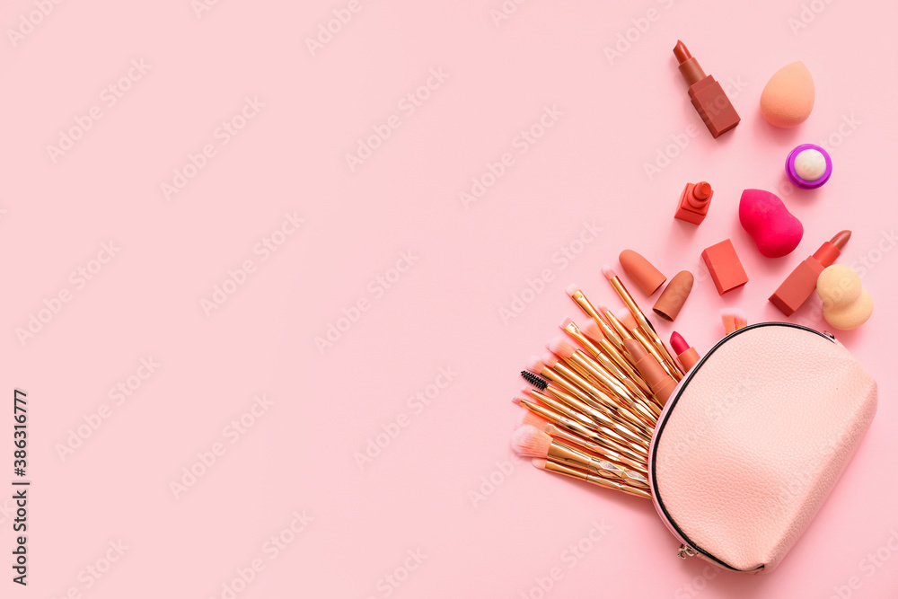 Set of makeup brushes with decorative cosmetics on color background