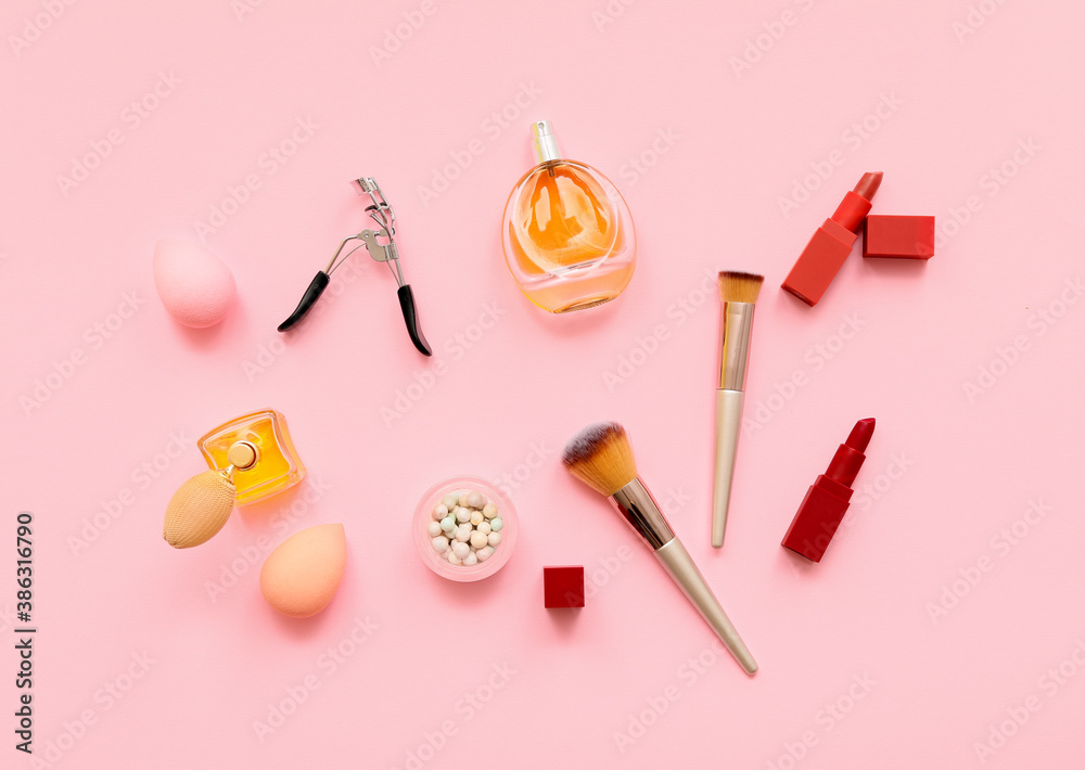 Set of makeup brushes with decorative cosmetics on color background