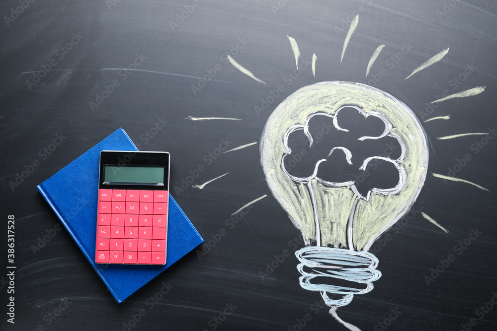 Creative composition with drawn lightbulb and stationery on chalkboard