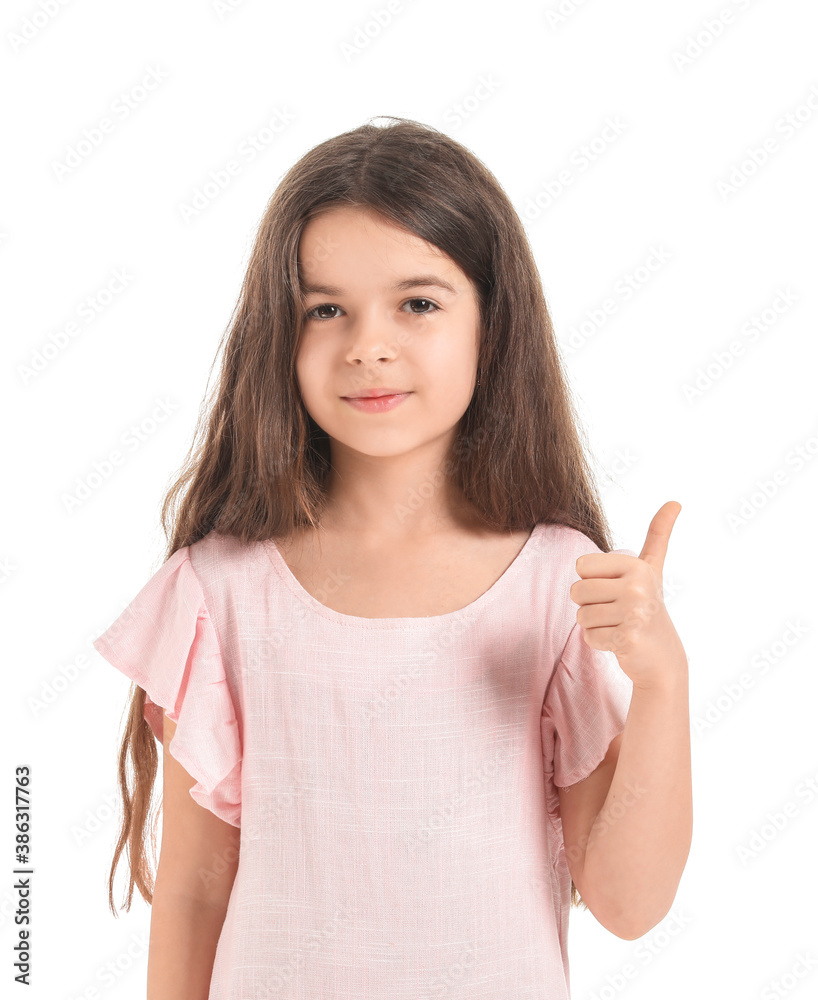 Cute little girl showing thumb-up gesture on white background