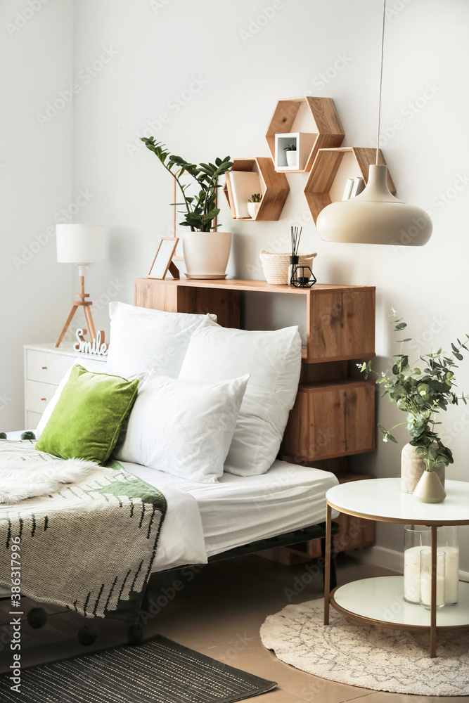 Interior of modern stylish bedroom with shelves