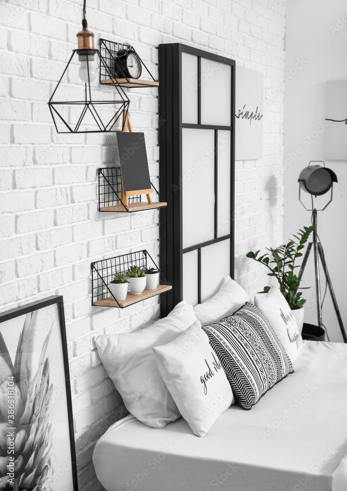 Interior of modern stylish bedroom with shelves