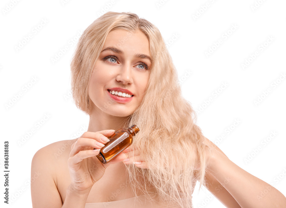 Beautiful young woman with cosmetic oil on white background