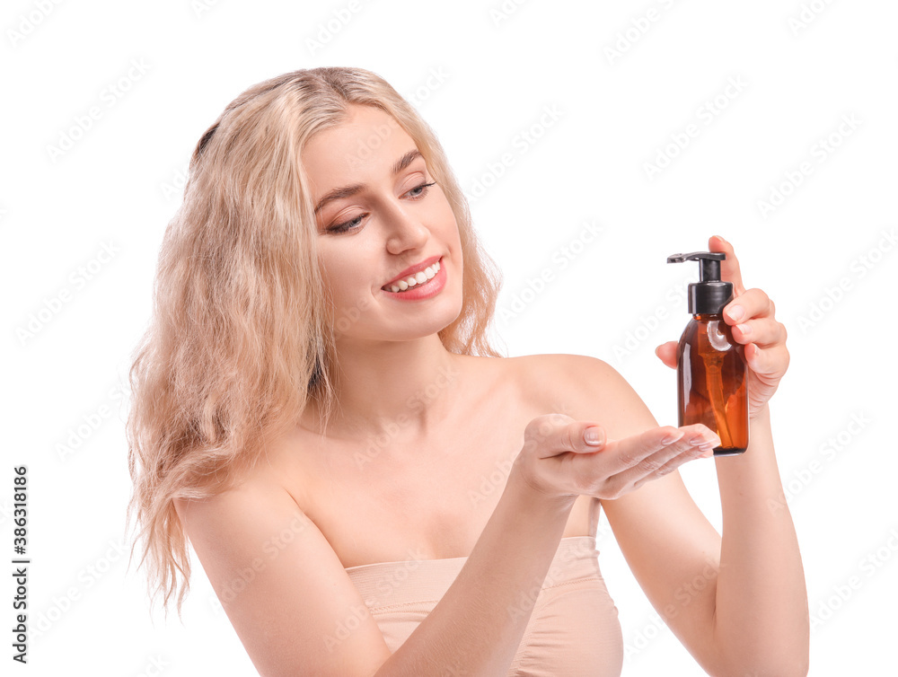 Beautiful young woman with cosmetic oil on white background