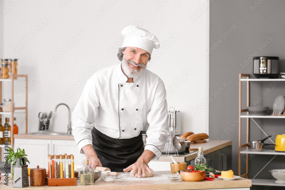 Mature male chef cooking in kitchen