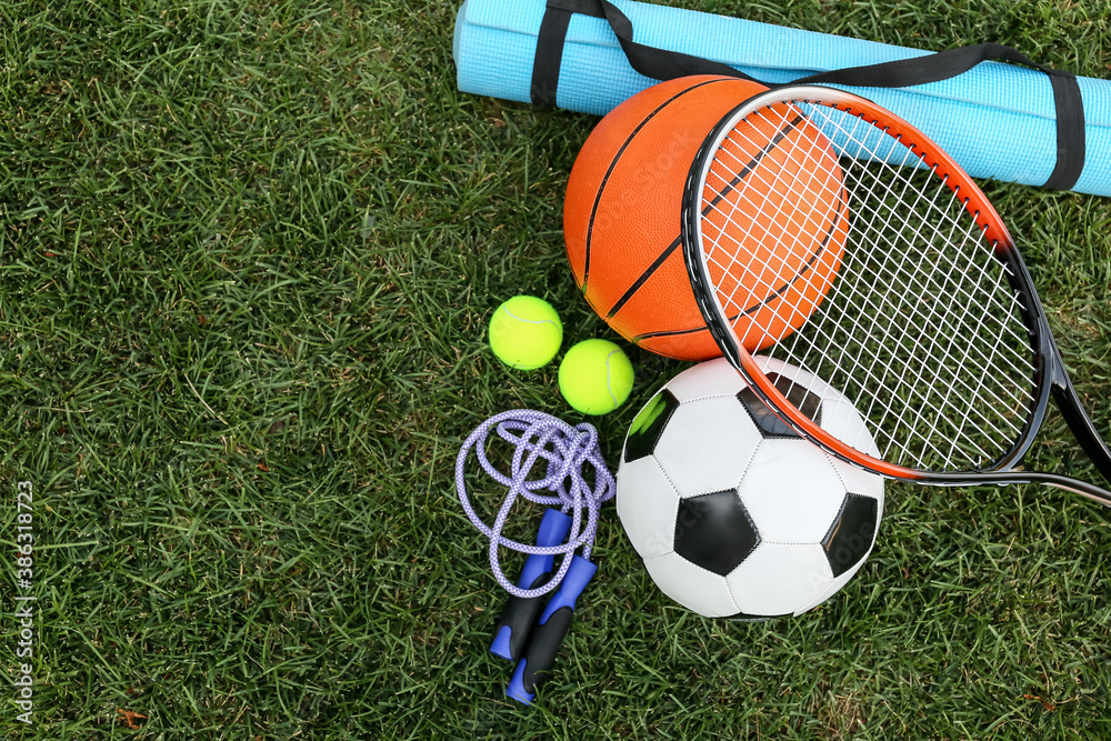 Set of sport equipment on green grass