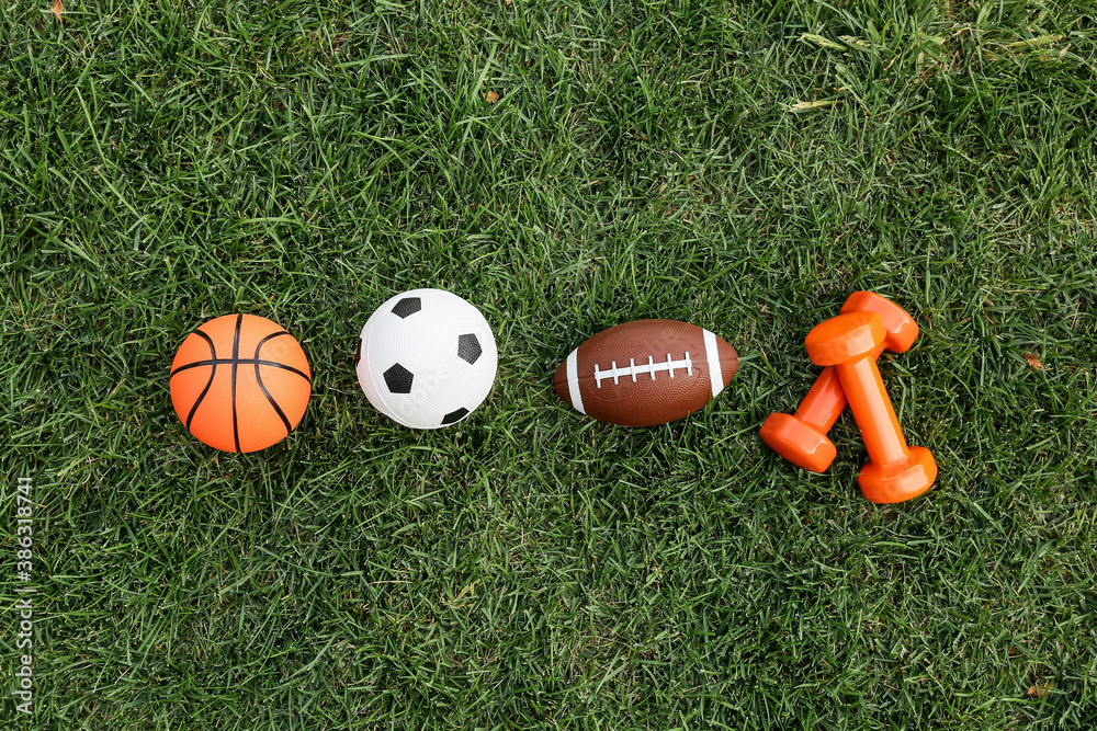 Set of sport equipment on green grass