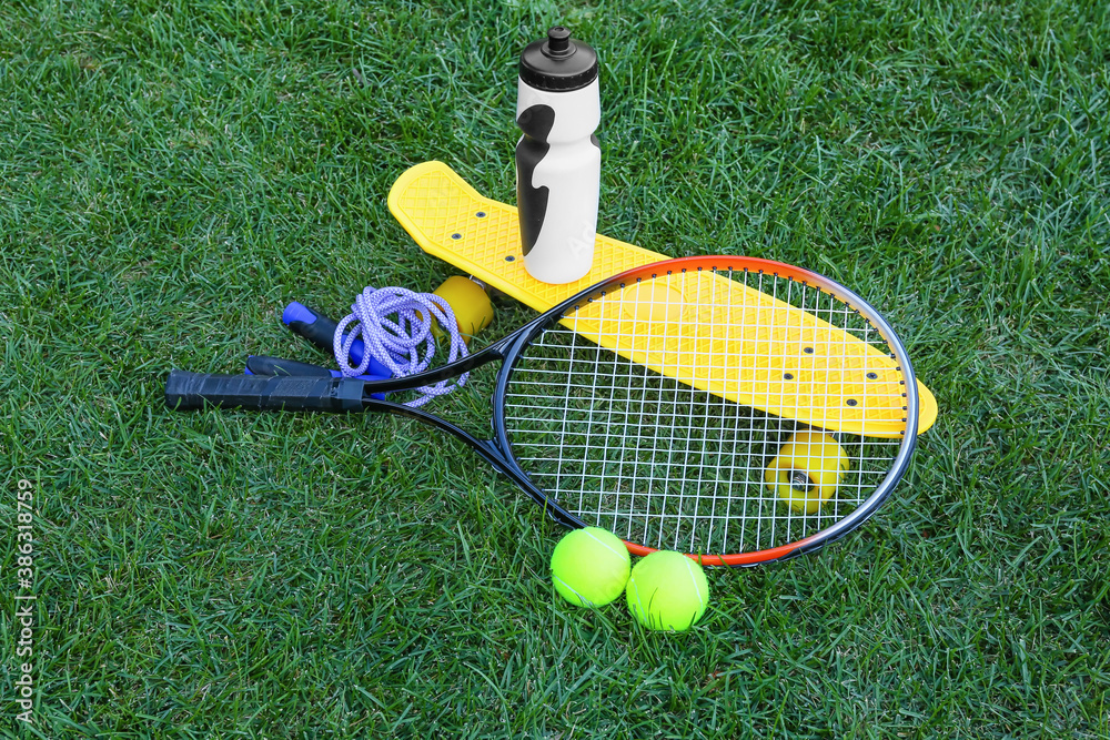 Set of sport equipment on green grass