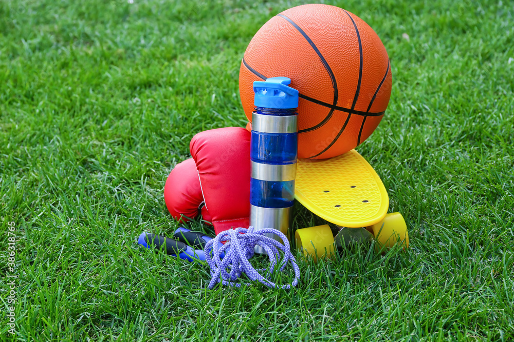 Set of sport equipment on green grass