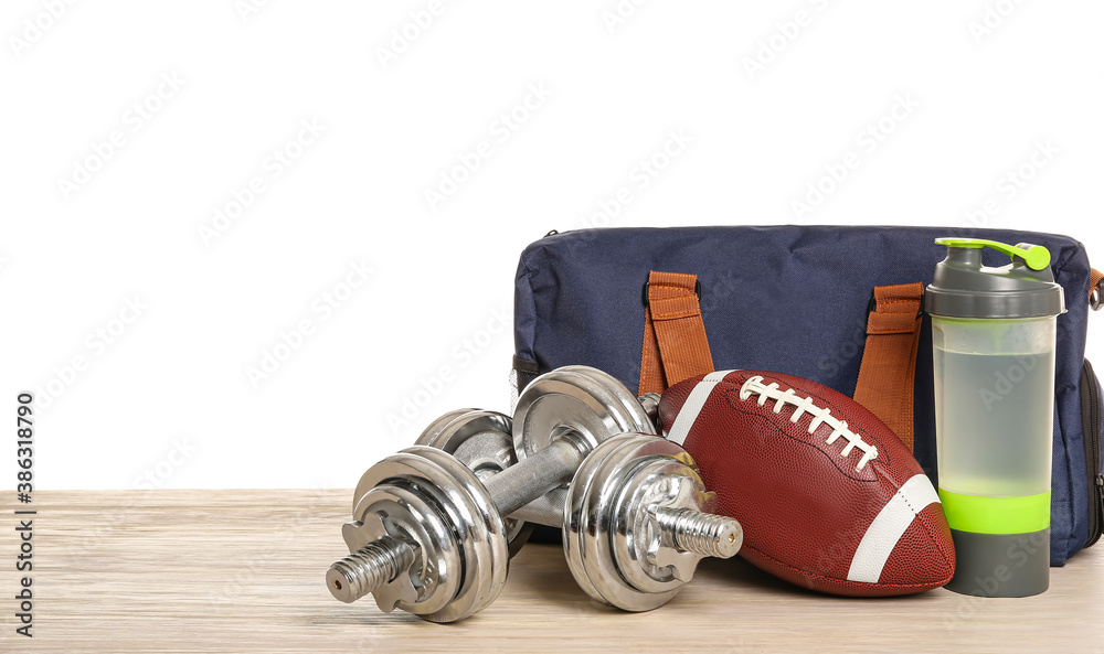 Set of sport equipment on table against white background