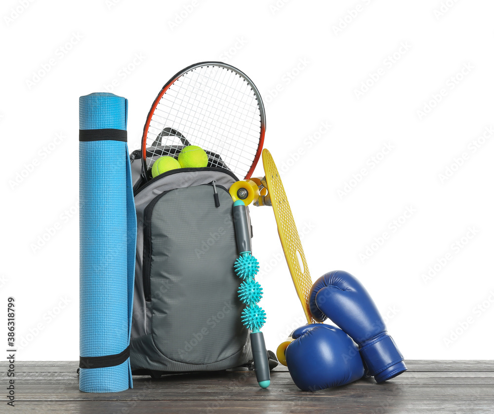 Set of sport equipment on table against white background