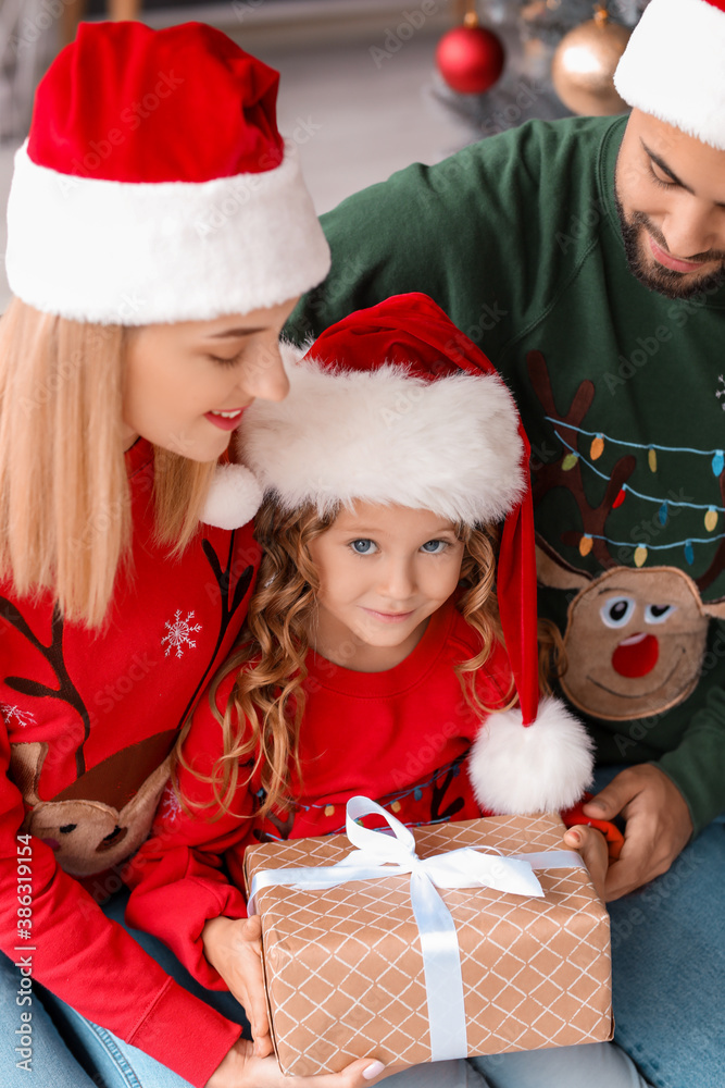 Young family with Christmas gift at home