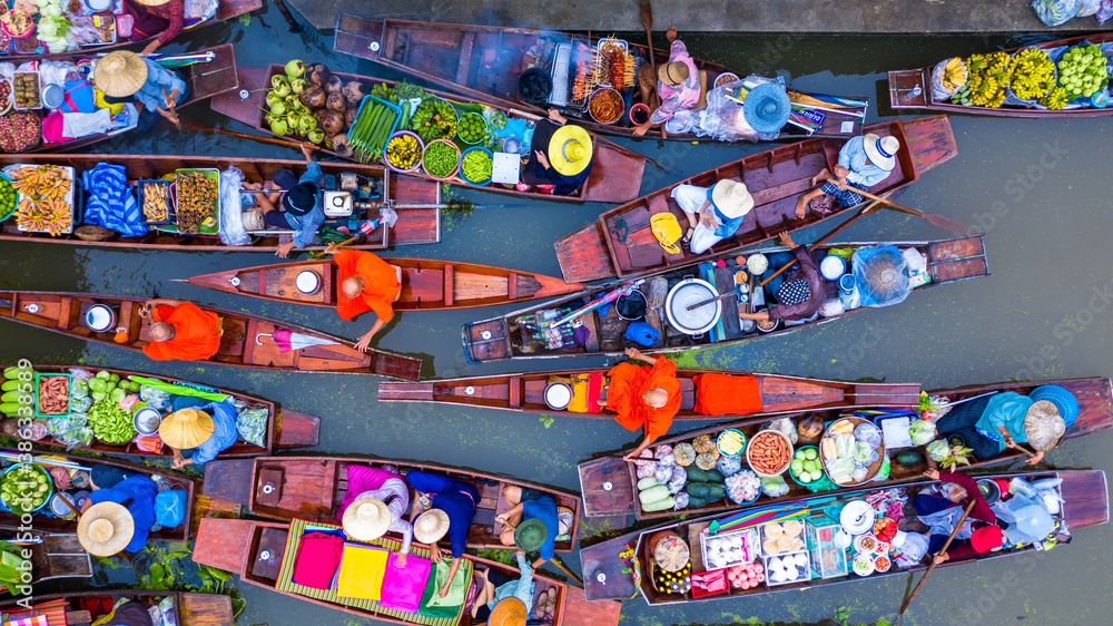 Aerial view famous floating market in Thailand, Damnoen Saduak floating market, Farmer go to sell or