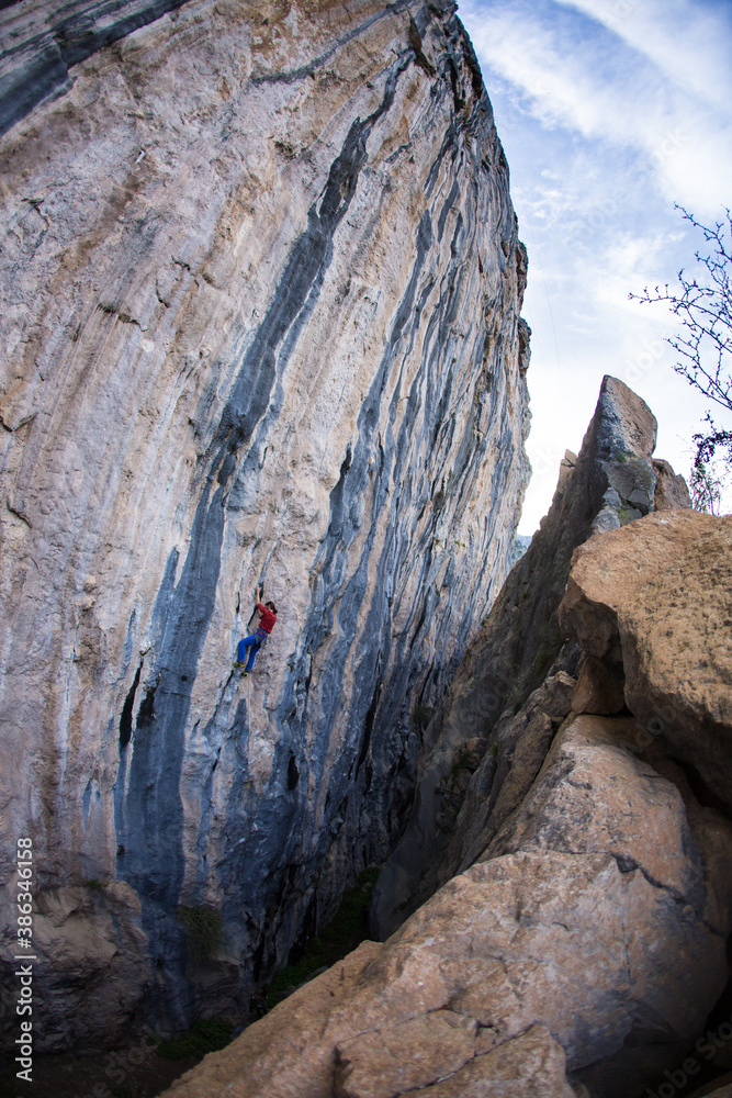 A strong man climbs a rock, Rock climbing in Turkey.