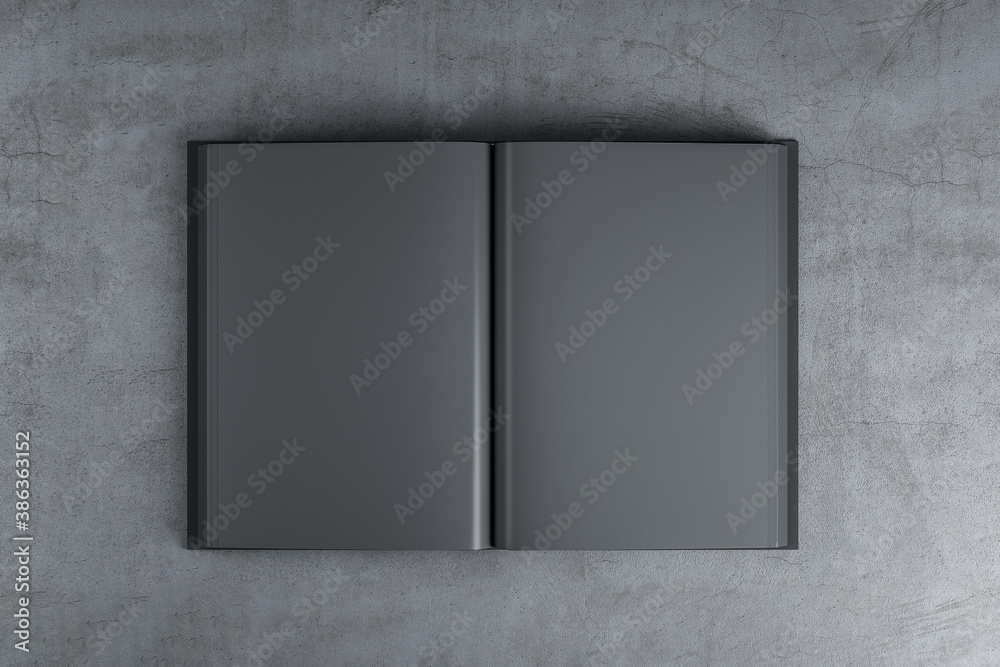 Abstract open black book standing on concrete table.