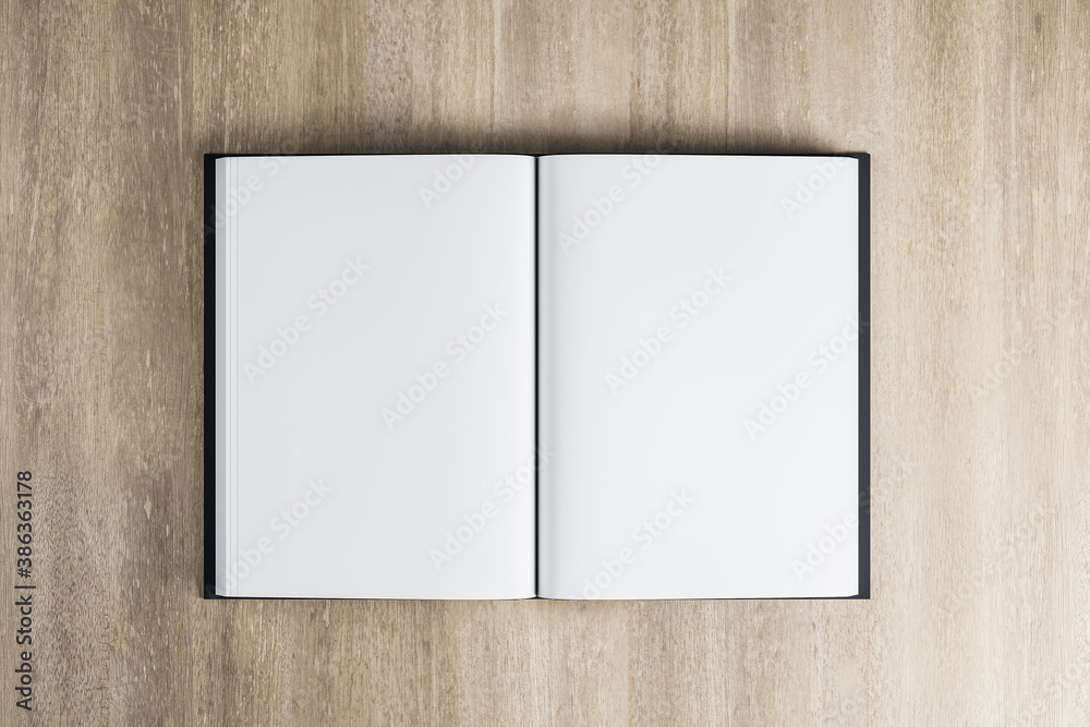 Top view of open book on wooden table.