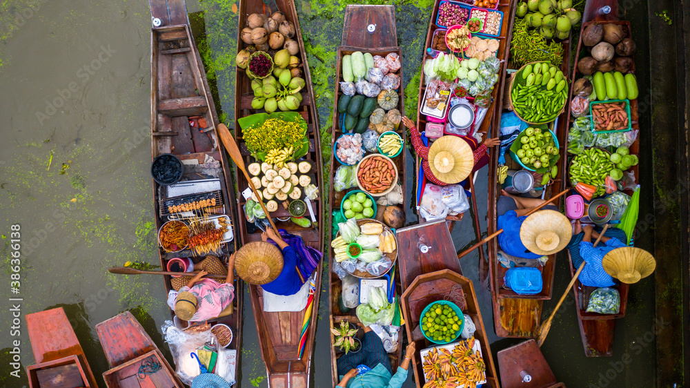 Aerial view famous floating market in Thailand, Damnoen Saduak floating market, Farmer go to sell or