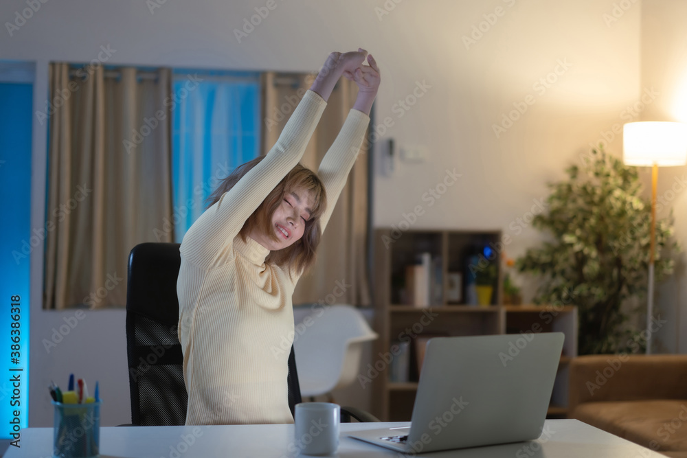 Asian woman, she stretches and relaxes, she works at night.