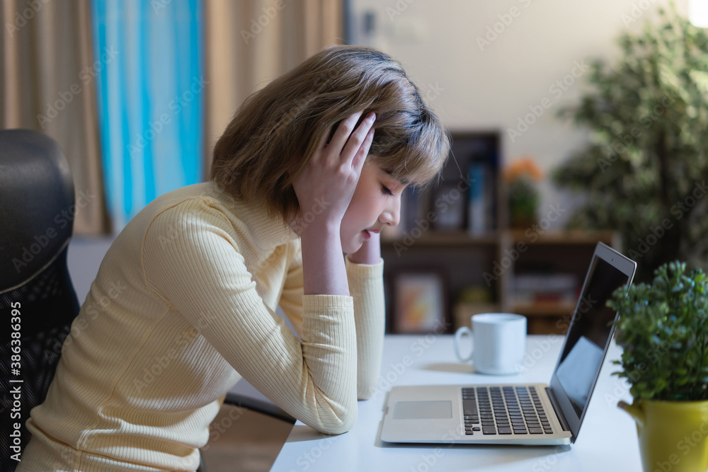 Asian woman Work at night She overworked.She is stressed In her home office