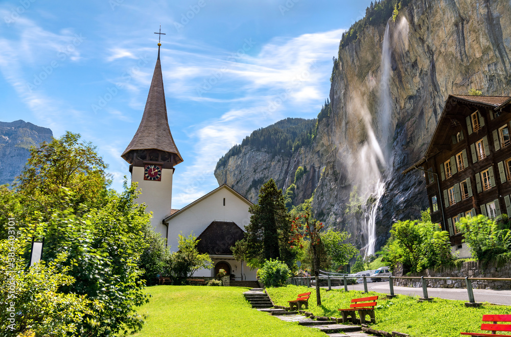 The village church and the Staubbach Falls in Lauterbrunnen - the canton of Bern, Switzerland